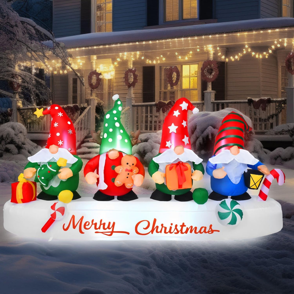 Inflatable group of four Christmas gnomes in red and green hats on a Merry Christmas base