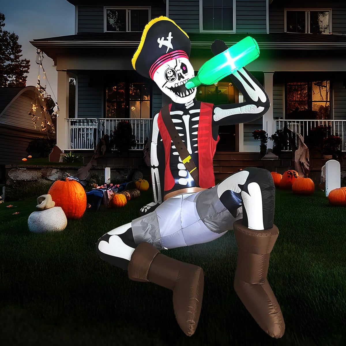Inflatable pirate skeleton in a black tricorn hat sitting on a barrel and raising a glowing green bottle on a lawn at night